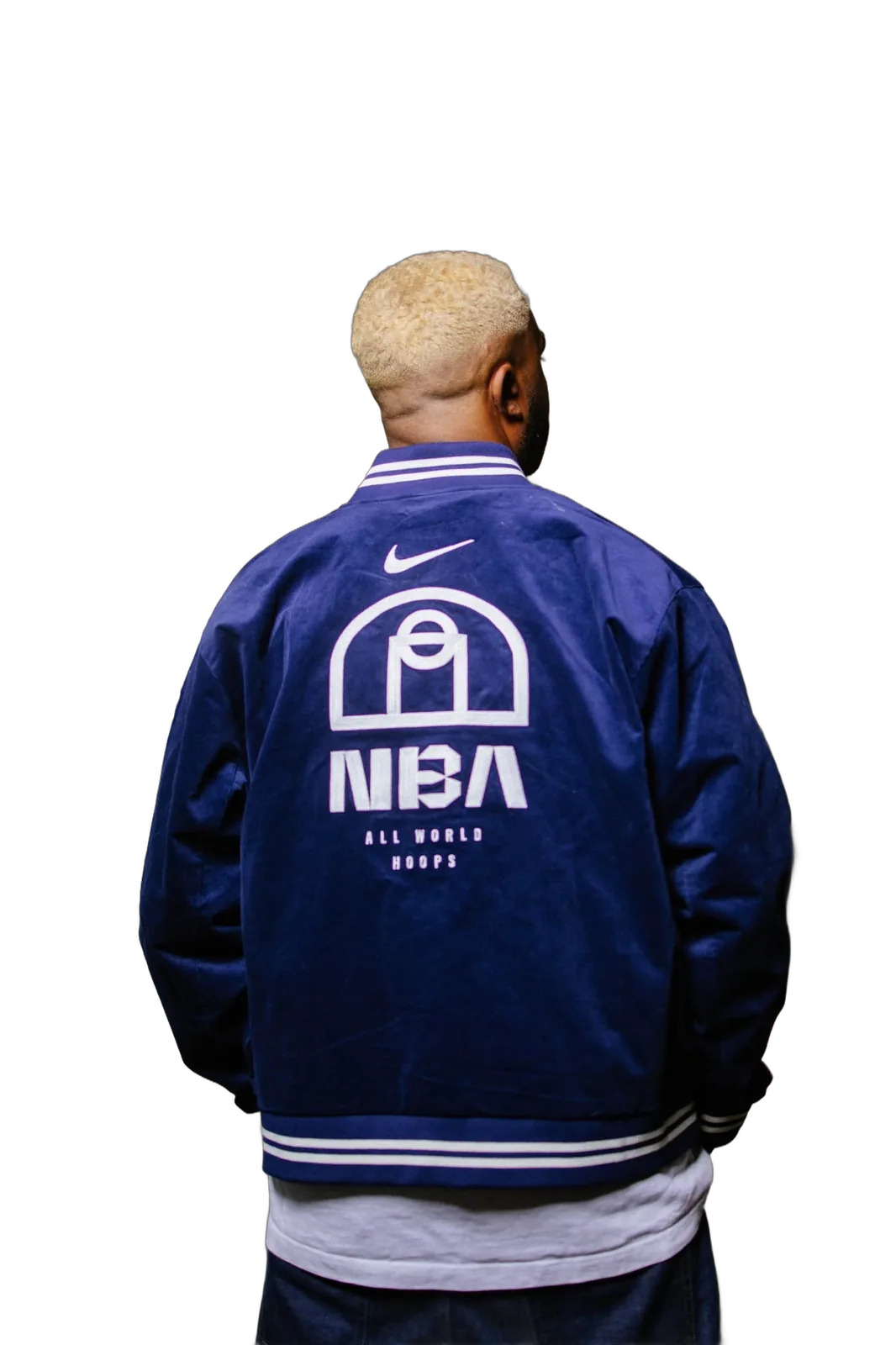 Manuelo from behind, blue jacket, under a concrete bridge